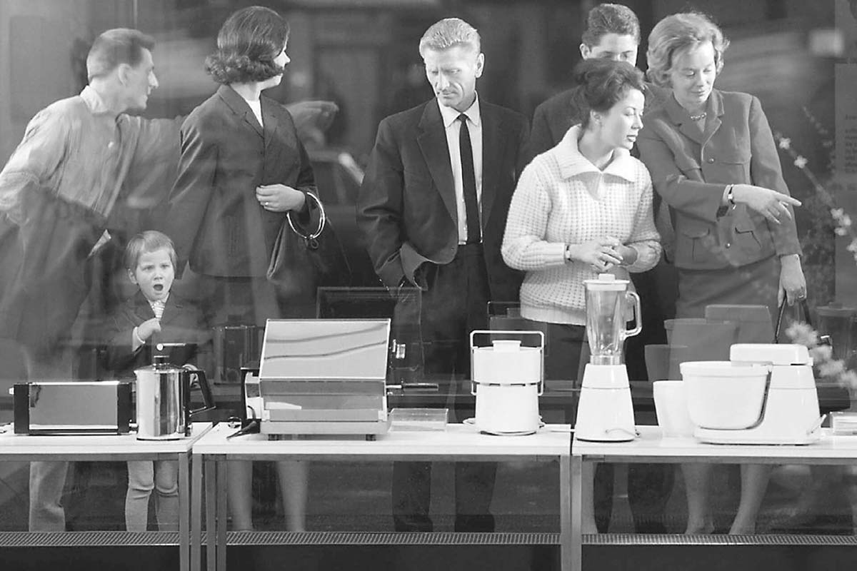 Visitors look at Braun products at a trade fair, 1950s